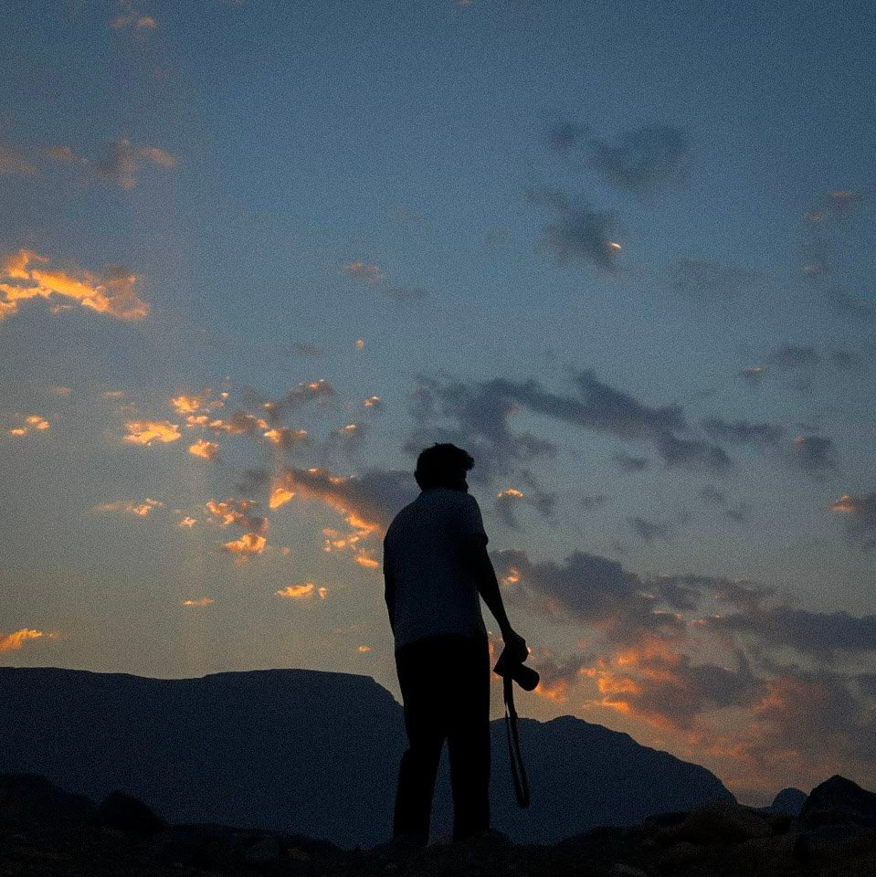 Silhouette against mountain dusk — stand-in for High Camp light